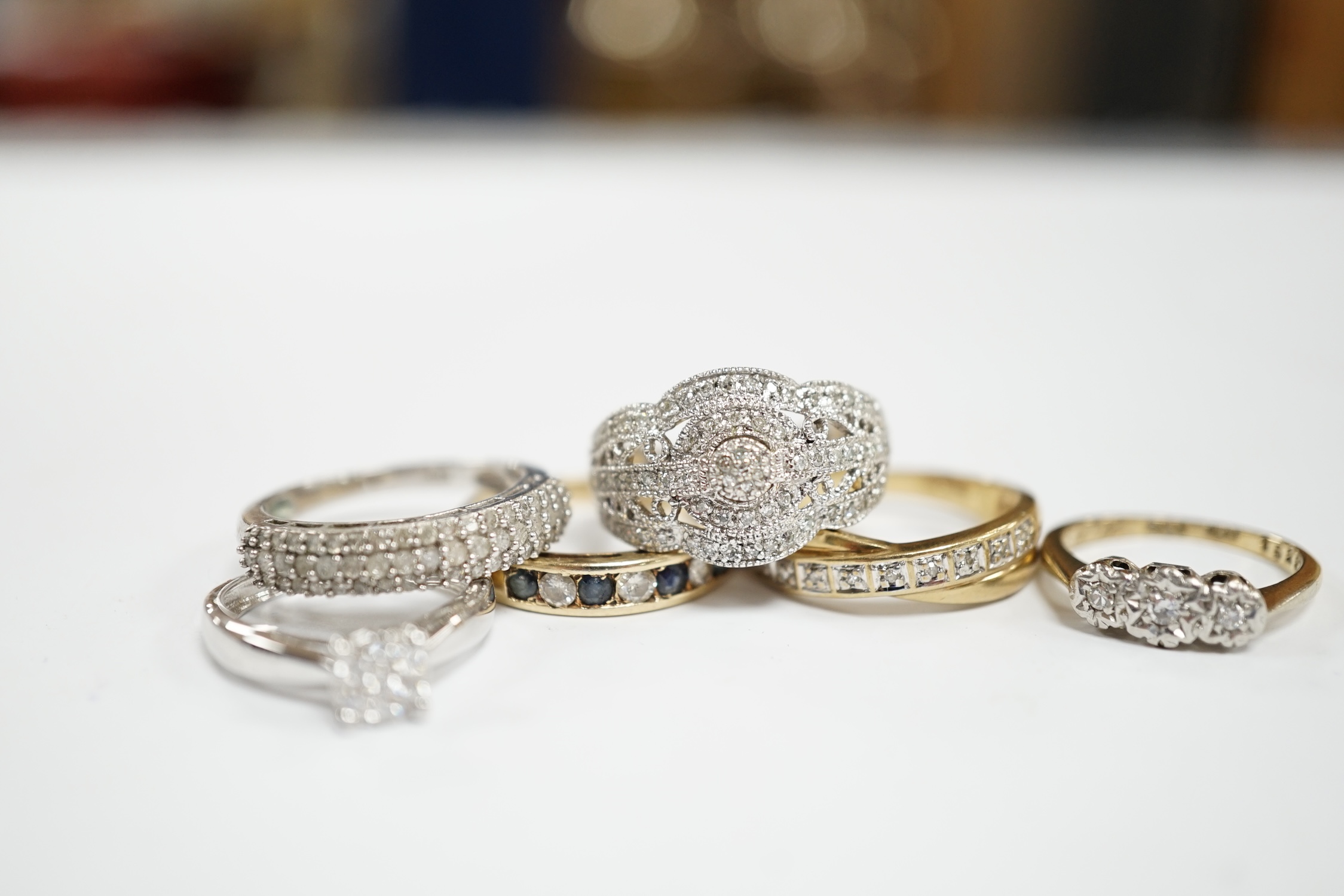 Five assorted modern 9ct and gem set rings including diamond chip cluster and sapphire and diamond chip, gross weight 12.7 grams, together with a 925 and diamond chip cluster set ring.
